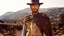 Clint Eastwood as The Stranger in A Fistful of Dollars, he's stood with a thin cigar in his mouth, cowboy hat on his head, looking sternly at something.