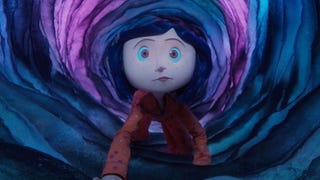 A still from Coraline, showing the titular character wearing pyjamas crawling through a mysterious, slightly glowing, circular cave.