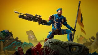 A toy soldier stands atop of a lot of broken toys, wielding a gun, holding a flag.