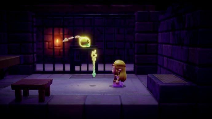 Zelda is stood talking to a floating, sentient orb of some kind, a staff floating in front of her in The Legend of Zelda: Echoes of Wisdom.